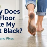 Bare feet with black dirt marks on a floor beside a mop, illustrating why floors can make feet black