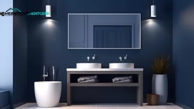 Blue and Gray Bathroom Ideas: Modern vanity with navy cabinetry, gray marble countertop, and brass fixtures.