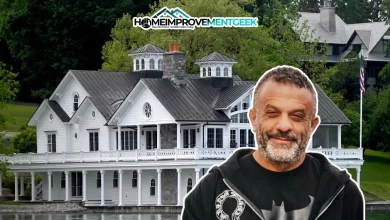 The image displays the Adam Weitsman House, a stunning white mansion with classic architectural details, including multiple gables, cupolas, and spacious wraparound porches.