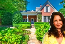 Ashley Judd house exterior view showing historic brick farmhouse with stone walkway and lush landscaping in Tennessee
