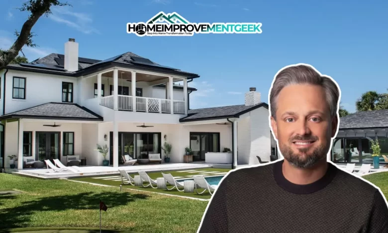 Cozy living room in Nate Bargatze’s house with rustic stone fireplace and high ceilings.