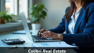 Person studying Colibri Real Estate online courses on laptop with real estate books and house keys on desk