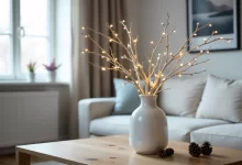 Pyntekvister decorative branches with LED lights in white vase on wooden table in Nordic living room