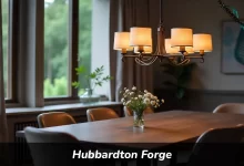 Hubbardton Forge handcrafted chandelier hanging over dining table showing wrought iron metalwork and bronze finish