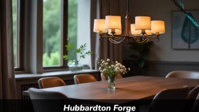 Hubbardton Forge handcrafted chandelier hanging over dining table showing wrought iron metalwork and bronze finish
