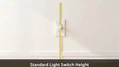 Standard light switch height measured at 48 inches from floor with tape measure on residential wall