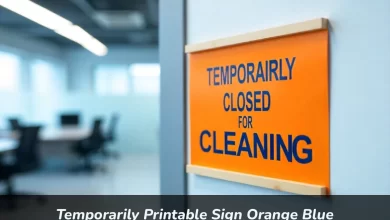 Temporary printable sign in orange and blue saying "Temporarily Closed for Cleaning" on a wall