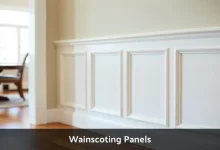 White wainscoting panels installed on lower wall in modern dining room showing raised panel design with chair rail molding