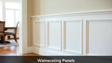 White wainscoting panels installed on lower wall in modern dining room showing raised panel design with chair rail molding