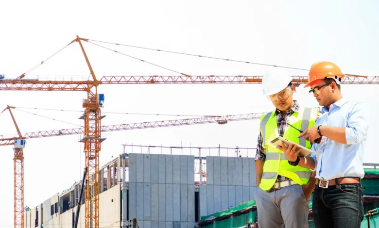 Construction solutions showing modern building site with steel framework, concrete foundation, and skilled workers using quality materials