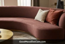GoodMoodDotCom.com home decor featuring curved sofa with warm earth tones, natural wood furniture, and sustainable designer accents