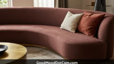 GoodMoodDotCom.com home decor featuring curved sofa with warm earth tones, natural wood furniture, and sustainable designer accents