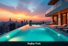 Rooftop pools with infinity edge and city skyline views at sunset featuring modern design and lounging area
