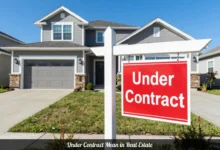 under contract in real estate sign in front of modern home with blue sky