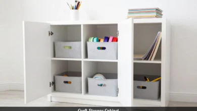Craft storage cabinet with open doors showing organized drawers and shelves for art supplies and crafting materials
