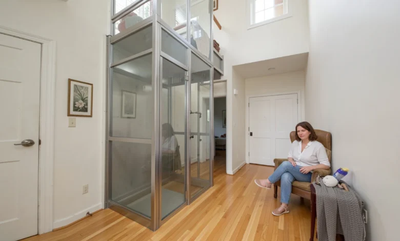 Home Elevators: Complete Guide to Cost, Types, Installation & Safety (2026) - Home Safety | HomeImprovementGeek Modern Home Elevators with glass panels installed in a residential hallway next to a wooden staircase