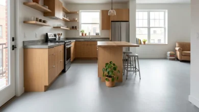 Sheet vinyl flooring installed in a modern kitchen with grey tones and natural lighting