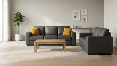 Charcoal leatherette sofa set in a modern living room with wooden coffee table and throw cushions
