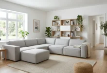 A modular furniture living room with a gray L-shaped modular sofa and white wall shelving unit