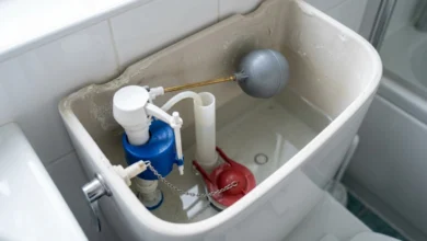 Inside view of a toilet tank showing flapper, fill valve, and float