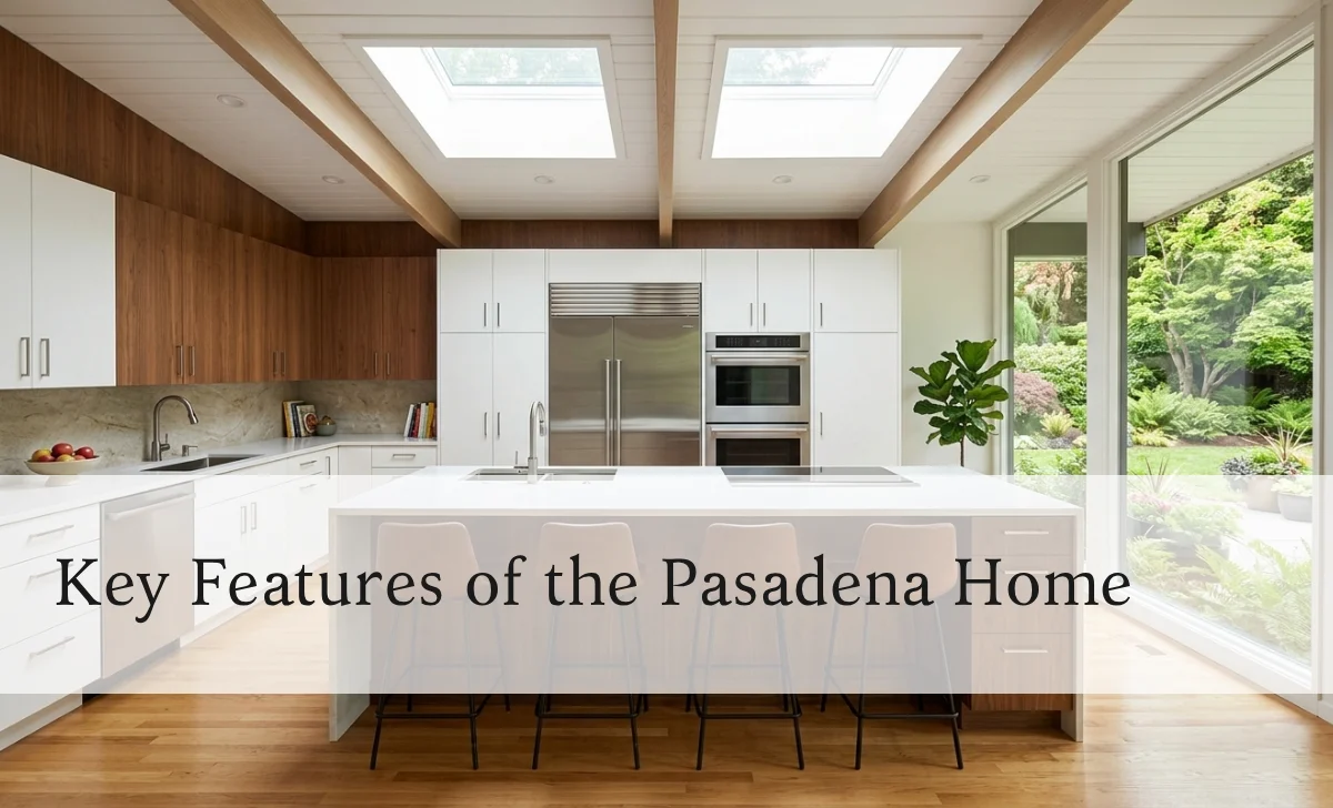 Kitchen inside Steven Yeun house with white cabinets skylight and island breakfast bar