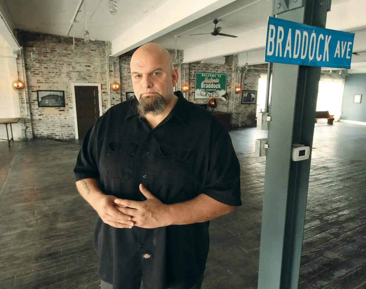 John Fetterman standing inside his converted Braddock dealership loft